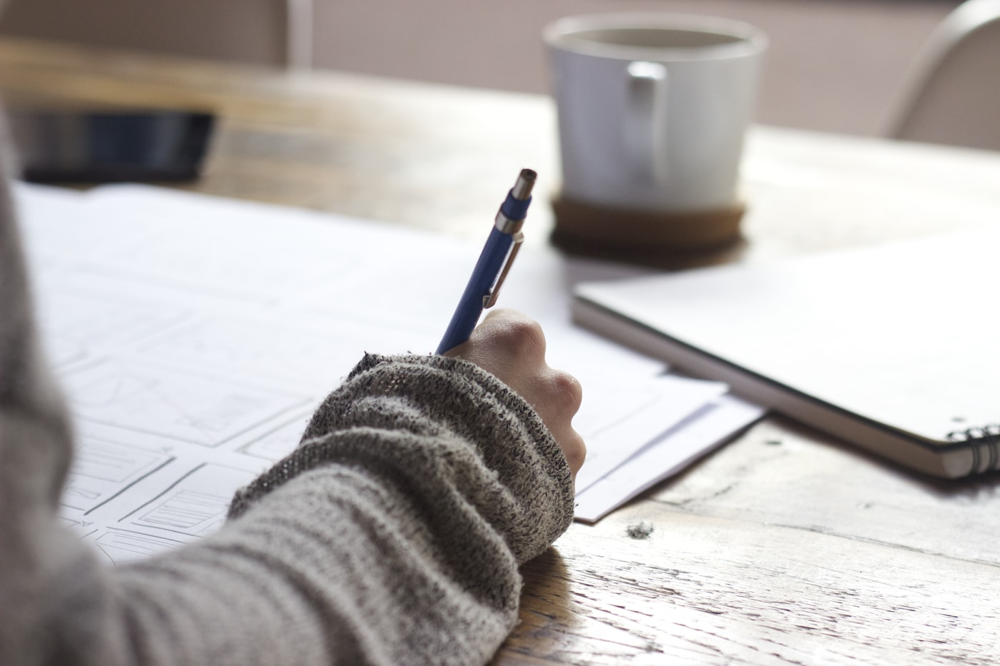 Notebook and planning materials on a desk for service packaging